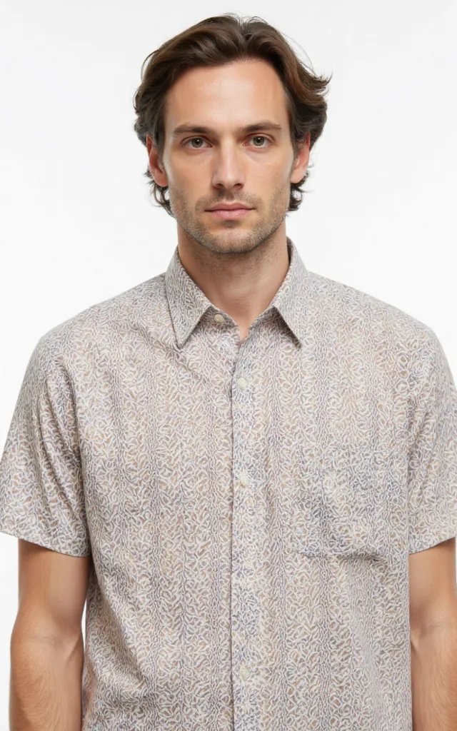 A French model wearing a Braid pattern   printed shirt, against a white background, in a front   facing bust portrait